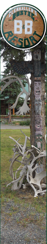 Exterior of B and B with caribou shed and totem pole decorations